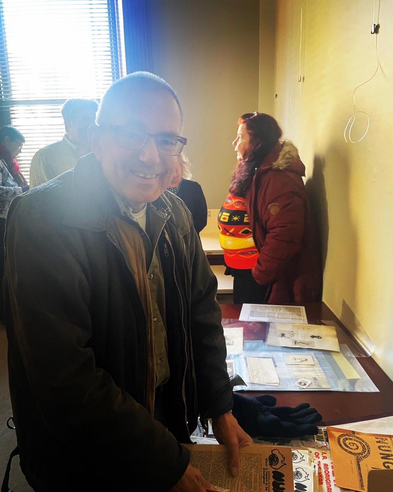 Andrew Wilson looking through the display featuring Nunga News. 