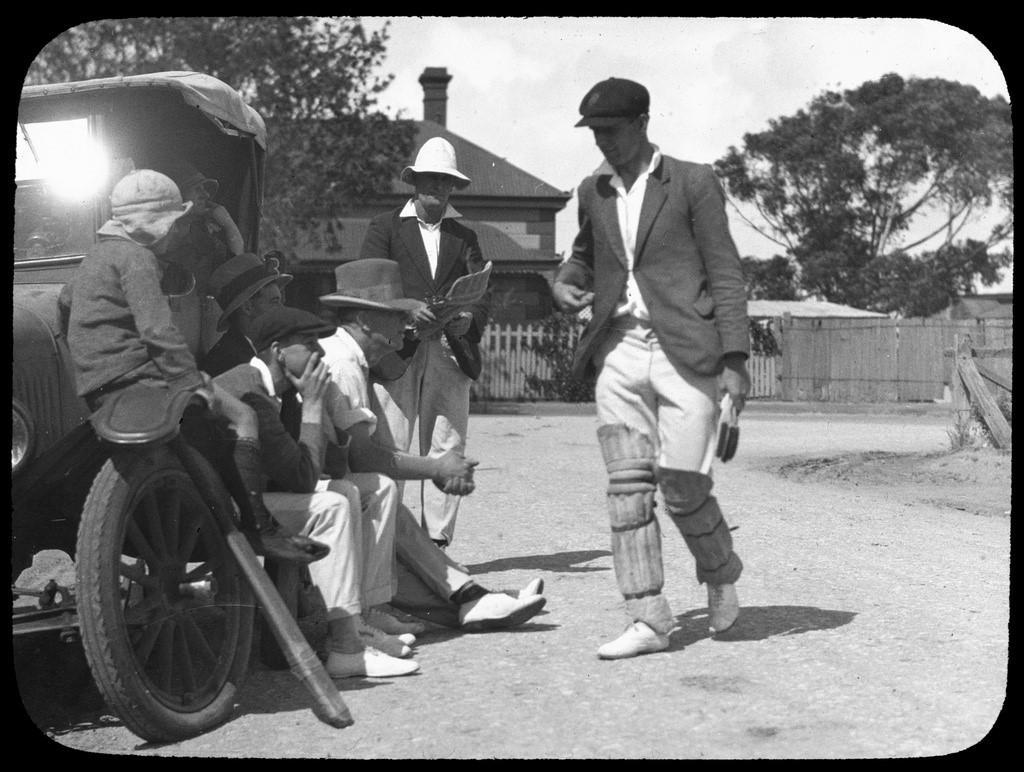 Off-field cricketer-greeting four men-woman-and child-at-vehicle-c1927