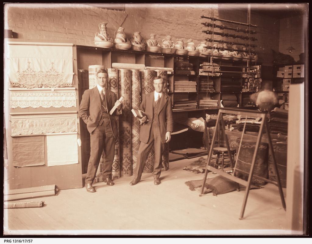 Two employees in front of WC Brooke& Co. furnishings display