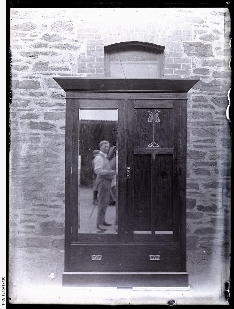 Mirrored wardrobe showing reflection of photographer WC Brooker