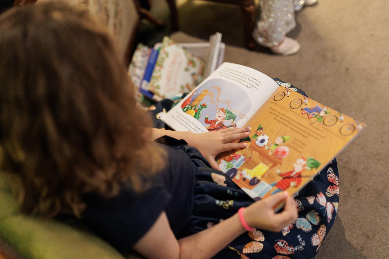 Young girl reading a Christmas book