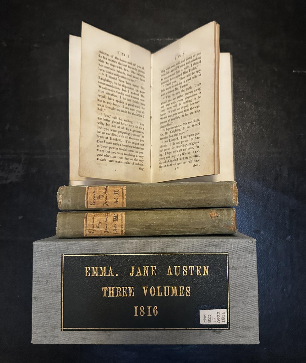 A photo of Jane Austen's novel Emma in three editions and box.