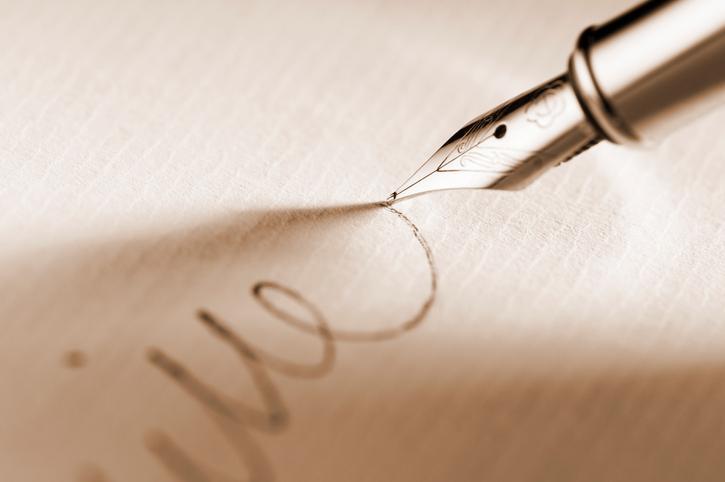 Bequests, Fountain pen writing on paper - iStock photo