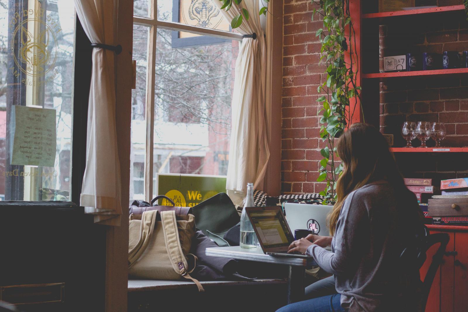 Lady  in cafe using a computer.