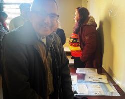 Andrew Wilson looking through the display featuring Nunga News. 