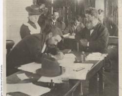 'At the Towitta Inquest. Detective Fraser completing Mary Schippan's statement. The Coroner is looking tired. Time 7 p.m.' Photograph published in 'The Critic' newspaper on 18 January 1902 SLSA: B 75311/1 