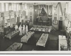 Interior of the Burra Hall set up for a dinner with five Cheer Up workers standing by. SLSA: SRG 6/34/14