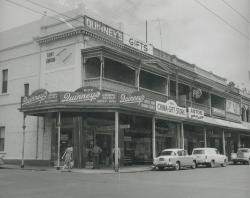 A group of shops on Rundle Street, Adelaide featuring Miss Gladys Sym Choon and the 'China Gift Store', 1961. SLSA: B 14563