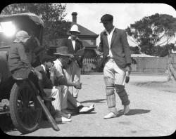 Off-field cricketer-greeting four men-woman-and child-at-vehicle-c1927