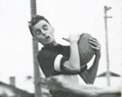 Footballer  caught in action marking the ball-c1920