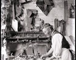 Brooker employeed measures wood in carpentry workdshop-c1911