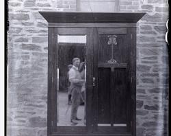 Mirrored wardrobe showing reflection of photographer WC Brooker