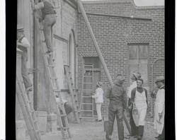 Church working bee shows men on ladders and other helpers