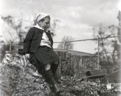 Young William Brooker in garden, with child-sized wheelbarrow in background