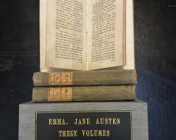 A photo of Jane Austen's novel Emma in three editions and box.