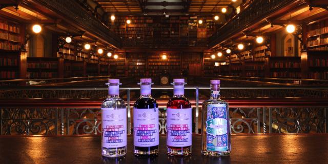 Four bottles of gin bar on a table with the Mortlock Chamber as a backdrop