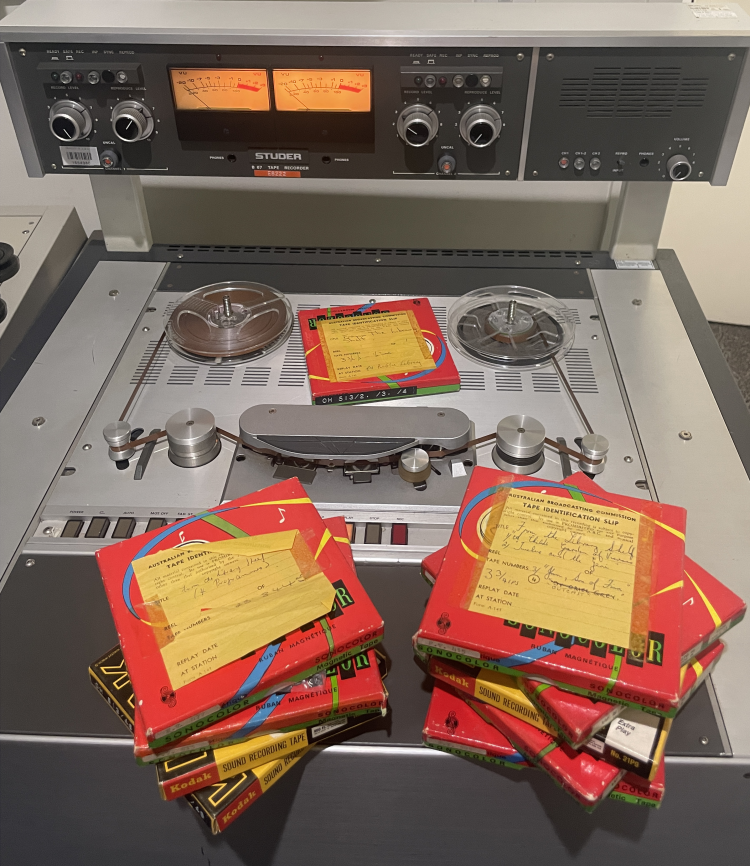 Tape boxes containing the reels of the ABC radio program 'From the Library Shelf' in he Audio Preservation studio at the State Library. Photographed by Laura Wolfe.