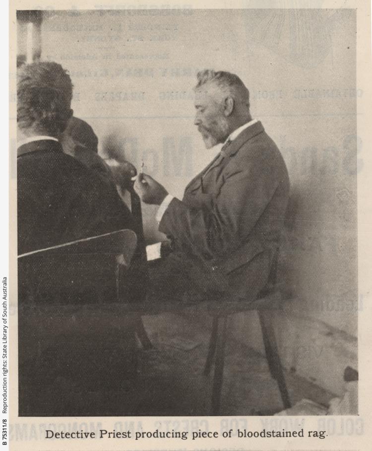 'Detective Priest producing piece of bloodstained rag' . Photograph published in 'The Critic' newspaper on 18 January 1902. SLSA: B 75311/8 