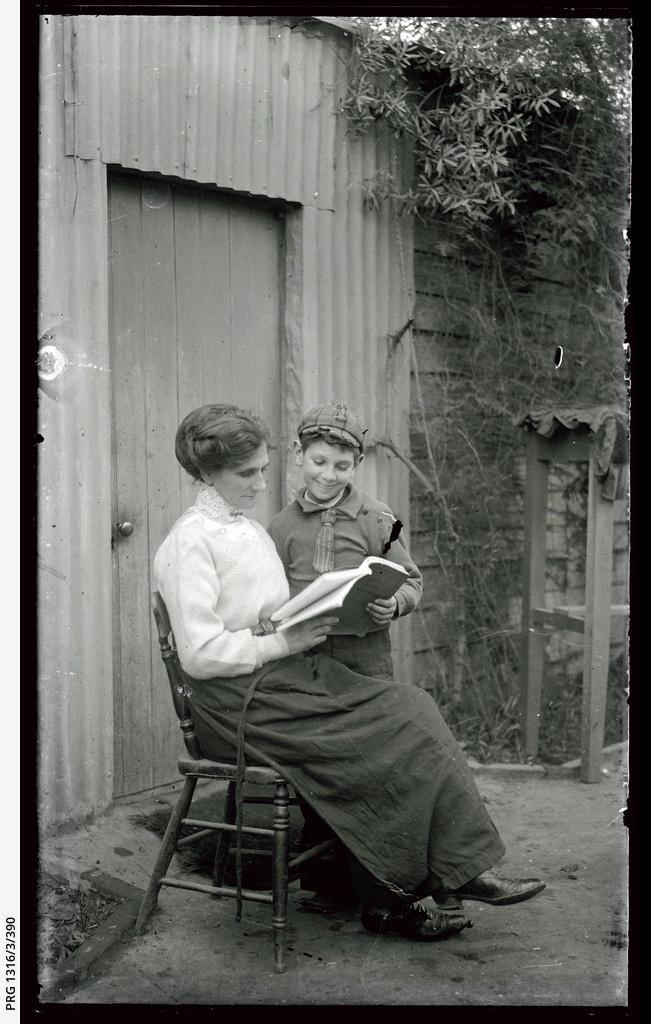 Emily Brooker reading to son William in garden