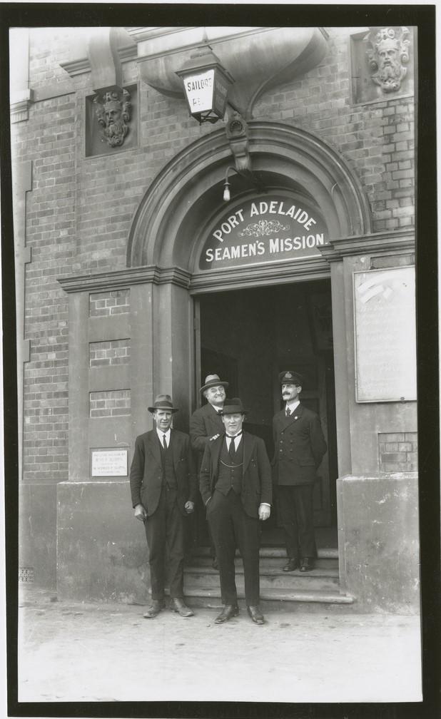 Four men stand in entrance of Port Adelaide Missions to Seamen-c1925