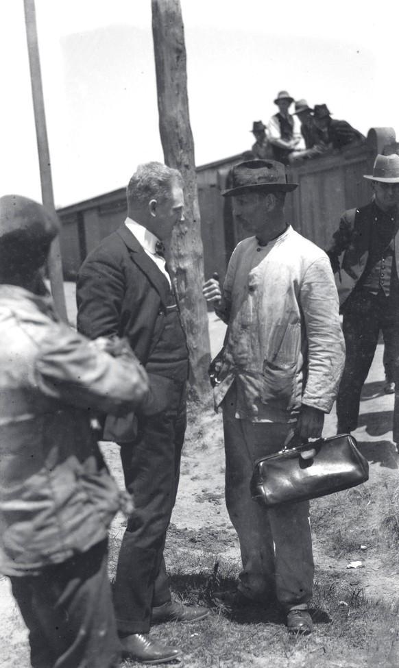 Visiting American evangelist Dr Jesse Kellems with railway worker-Adelaide Railway station yards-1923